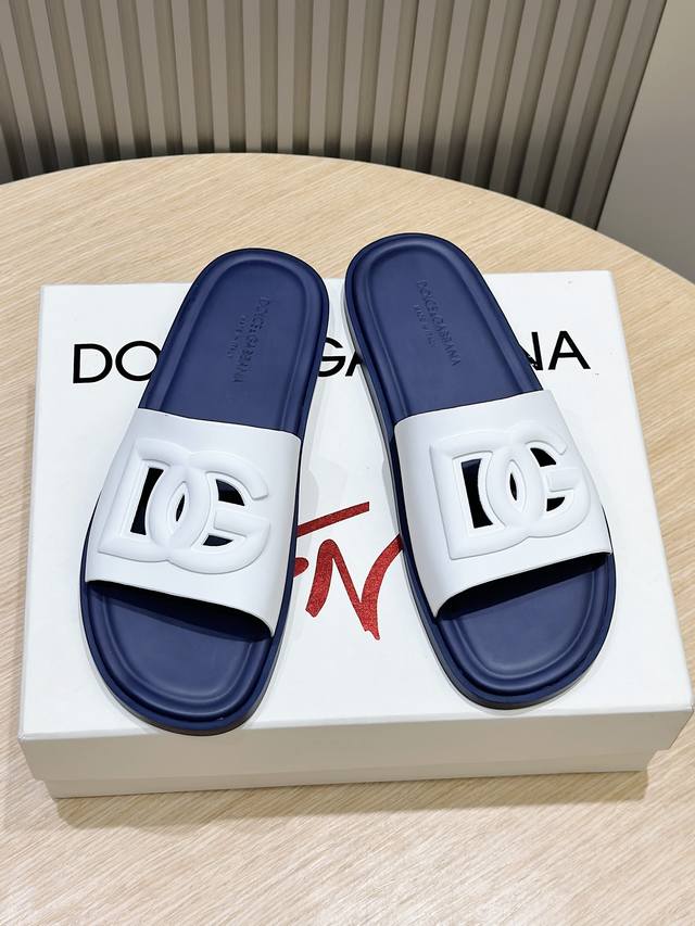 D&G24款橡胶男士dg徽标沙滩拖鞋 Dg徽标点缀在鞋面，镂空穿孔的设计灵动又不失经典。带有橡胶标志标签的鞋垫，细节满分。 Size:39-44 38.45定做
